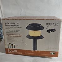 Box front showing product image, description, and quantity 4 pack. Brand Hampton Bay indicated. Shows some box wear.