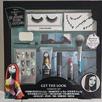 Front of the boxed cosmetic kit showing all individual cosmetic items inside with Disney's Nightmare Before Christmas branding and character images.