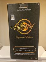 Black NutriChef branded box labeled 'Home Bar Whiskey Decanter, Signature Edition', showing brand and product details on front.