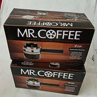 Two boxed Mr. Coffee replacement decanters stacked and shown front side with brand and item details.