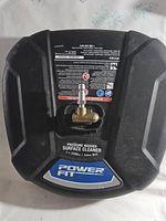 Photo of the top of the Powerfit pressure washer surface cleaner attachment showing brand label and connection fitting.