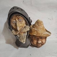 Close-up top view of Don Quixote and Sancho heads showing paint wear and detailing