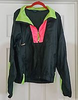 Front view of Columbia jacket showing neon green collar and pink partial zip placket