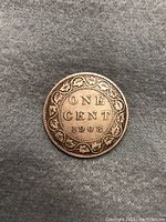 Reverse side of the 1908 Canadian One Cent coin showing 'ONE CENT 1908' with leaf wreath.
