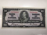 Front view of the 1937 Canadian $10 banknote showing the King George VI portrait, serial number Y1758221, signatures and denomination in English and French.