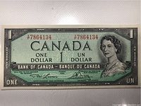 Front view of 1954 Canadian one dollar banknote showing Queen Elizabeth II portrait, serial number 7864134, bilingual text, and signatures.