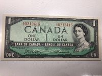 Front side of the 1954 Canadian one dollar banknote showing Queen Elizabeth II portrait and serial number.