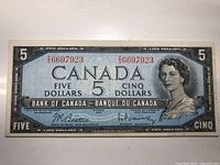 Front side of the 1954 Canadian $5 banknote with serial number and Queen Elizabeth II portrait.