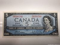 Front view of the 1954 Canadian $5 banknote showing Queen Elizabeth II portrait, serial numbers, and bank signatures.