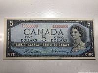 Front side of the 1954 Canadian $5 banknote showing Queen Elizabeth II portrait and serial numbers.