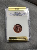 Front side of the 1962P 1 cent coin in SGS graded plastic holder.