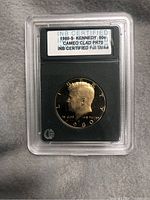 Photo of encapsulated 1980-S Kennedy half dollar coin showing certification label and coin obverse.