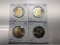 Four Canadian $2 coins in protective holders marked 2023, uncirculated from roll, front view showing bimetallic design and Discovery of Insulin theme.