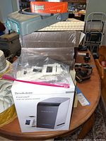 Brookstone iConvert box and Beseler slide holders on a table with magnifier on top