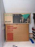 Original Sharp QT-50(P) box atop Sharp RD-670AV box