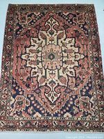 Full frontal view of rug laid flat showing central medallion and border pattern