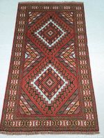 Full view of hand-knotted Persian wool rug with geometric diamond patterns and intricate borders in shades of red, brown, and light accent colors
