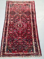 Full view of rectangular Persian rug showing overall design and color scheme