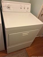 Full front view of the white Kenmore 90 Series electric dryer including control panel and door.