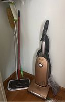 Riccar vacuum and cleaning tools grouped in closet corner