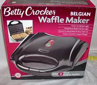 Front of the original box showing Betty Crocker Belgian Waffle Maker product with image of the appliance and waffles