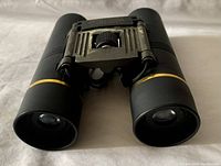 Front view showing lenses and foldable design with metal bridge and focus wheel