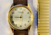 Close-up of Caravelle by Bulova watch face with dark nylon strap attached.