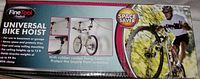 Box front showing Fine Tool Universal Bike Hoist image and features: space saver, rubber coated hooks, use in basement or garage, fits ceiling heights up to 13 ft, holds bikes up to 44 lbs.