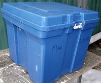 Blue Rubbermaid hard resin square storage box with hinged lid and metal latch, showing front and side views. Box marked with 'MAC' and 'LEOD' handwriting.