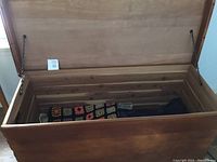 Open cedar chest showing cedar lining inside and crocheted blanket stored within.