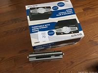 Box of Craig turntable with AM/FM stereo radio along with a vintage tape player displayed underneath it.