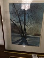 Framed signed watercolor print by J Wayne Bystrom showing a tree with shadow on snow, details of the artwork style and framing.