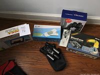 Overview photo showing Tundra light box on the left, AT&T Trimline telephone in box center, Yorkshire binoculars box on the right, and BinoCam box in front of Yorkshire box.