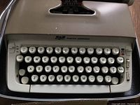 Top view of Smith-Corona manual typewriter showing keyboard and beige body with some wear spots.
