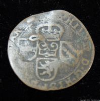 Photo of the coin's obverse showing crowned shield with heraldic details and surrounding text.
