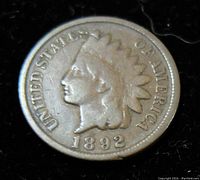 Obverse of the 1892 Indian Head penny showing Lady Liberty with feathered headdress and 'UNITED STATES OF AMERICA' inscription.
