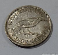 Obverse side showing a tui bird and the inscriptions 'NEW ZEALAND SIXPENCE 1941'.