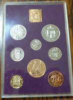 Set of 9 coins front view showing detailed reverse sides with British Heraldry and emblems.