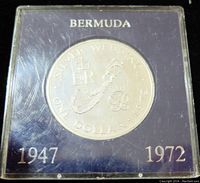 Front side of coin showing map of Bermuda, royal cypher, denomination and dates in protective case