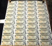 Full view of a laid out uncut sheet containing 10 Canadian 1973 $1 banknotes.