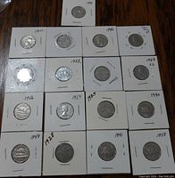 Seventeen old Canadian 5 cents coins displayed individually in white cardboard holders with years written above each coin, ranging from 1919 to 1959.