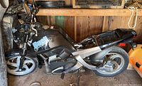 Side view of black Buell Blast motorcycle in shed