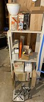 Shelf with boxed items including Black & Decker sander, vise, and other tool boxes.