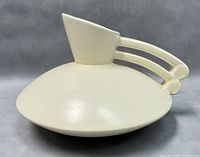 Side angle of the white mid-century modern atomic style pitcher with distinctive handle and wide base.