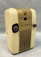 Photos show a compact vintage Westinghouse Little Jewel H-126 tube radio with cream and gold metal casing, brown knobs, and a carrying handle on top. The radio has visible wear marks and chipped paint spots, showing its age.