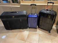 Three pieces of luggage in a row showing front and side views to capture overall size and style differences.