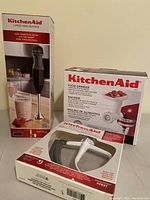 KitchenAid hand blender, food grinder attachment, and paddle attachment in original boxes.