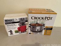Photo showing boxed Ninja Master Prep food and drink maker and Crock-Pot slow cooker side by side.