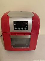Front view of red Todd English multi air fryer showing control panel with buttons and screen labeled MULTI AIR FRYER.