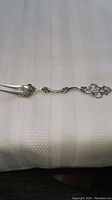 Top view of the vintage silver serving fork showing detailed ornate handle and prongs.